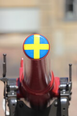 Swedish flag on canon in stockholm on holiday. Travelling with cruise ship in summer.
