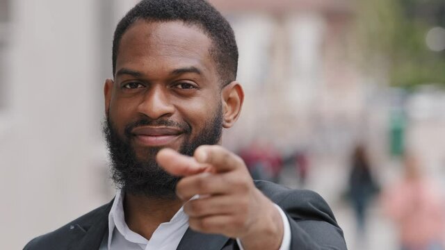 Headshot smiling man confident African ethnicity male HR manager headhunter point finger to camera welcoming applicant invites participate at job interview at company position. Business choice concept