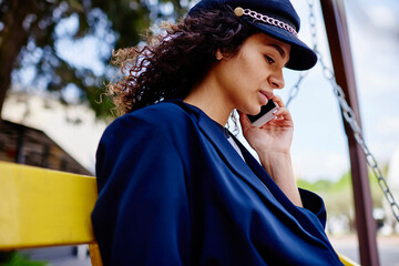 Calm ethnic woman speaking on phone