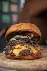 cheeseburger with caramelized onion on blurred background