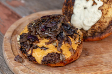 cheeseburger with caramelized onion on blurred background