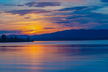 Naklejka na ściany i meble Summer sunset on the lake with mountain view