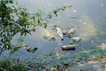pollution of ecology. Dirty lake with plastic bottles