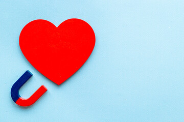 Fototapeta premium Dating love concept. Magnet with heart shapes, top view