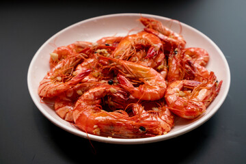 Delicious fried tiger prawns with minced garlic on the plate