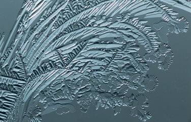 Blue patterns from frost on glass as a background.