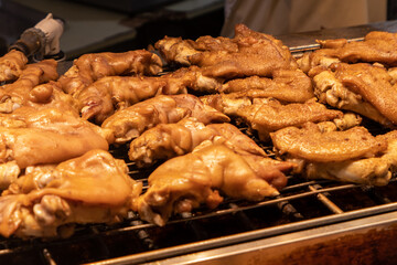 Delicious roast pig's feet. The chef is baking pig's feet