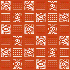 Seamless African mud cloth pattern with simple geometric shapes (dots, lines) and white tribal decoration on orange background