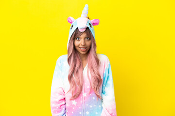 Young mixed race woman wearing a unicorn pajama isolated on white background with surprise facial...