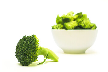 Fresh broccoli in a white cup isolated on white background.