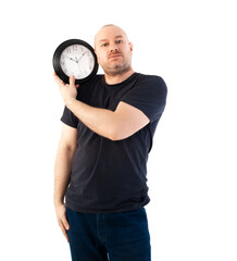 Deadline concept. A man in a T-shirt holds a large clock. Isolated on a white background.