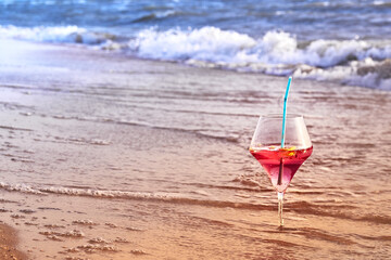 Wine glass with a cocktail by the sea.