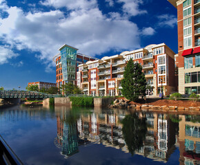 Luxury houses apartments in city overlooking reflective lake