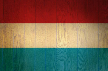 The flag of Luxembourg on a grunge wooden background.