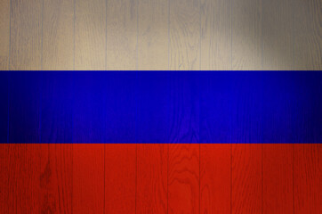 The flag of Russia on a grunge wooden background.
