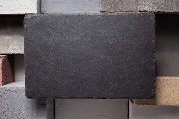 Slate stone background texture at concrete cube or construction brick