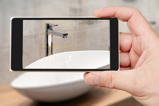 Water tap on smartphone screen. Water tap and sink in the bathroom. The interior of the living quarters.