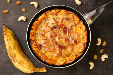 Malabar banana cake kayappola , pazham pola , banana pie made in skillet pan pie pot pie fruitcake made with eggs and Kerala banana for Ramadan, Eid . tea time snack breakfast dessert India Sri Lanka 