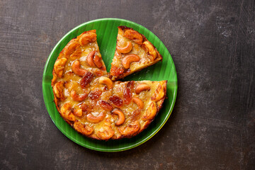 Malabar banana cake kayappola , pazham pola , banana pie made in skillet fruitcake made with eggs and Kerala banana for Ramadan, Eid . tea time snack breakfast dessert India Sri Lanka 