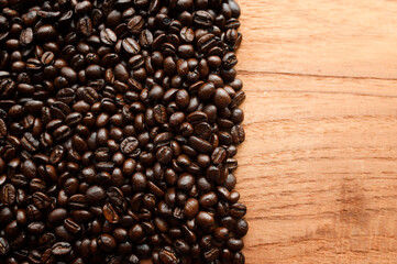 Coffee beans and hot coffee on the table roasted coffee beans background