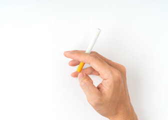 Hand holding cigarette isolated on white background.