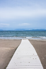 Wooden boardwalk or pathway on the sandy beach on the island