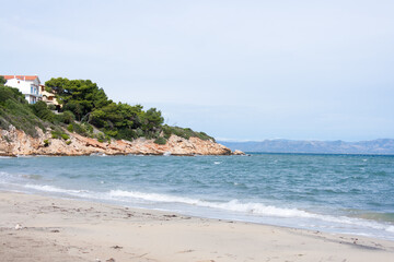 Fototapeta premium view of the beach and sea with little waves, resort on Sardinia island