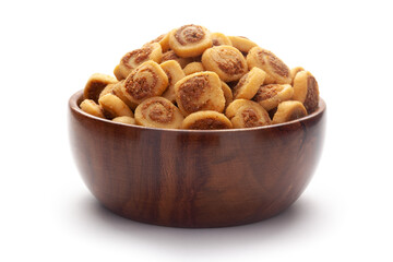 Close-up of freshly baked simple Bhakar Badi traditionally authentic Rajisthani cookies or biscuits In hand-made (handcrafted) wooden bowl.