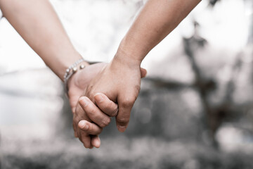 Conceptual image of female and male hands together, Couples holding hands.Summer in love.