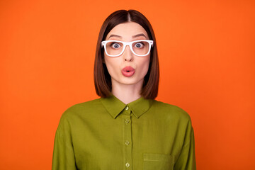 Photo of impressed brunette hairdo millennial lady wear eyewear khaki shirt isolated on orange color background
