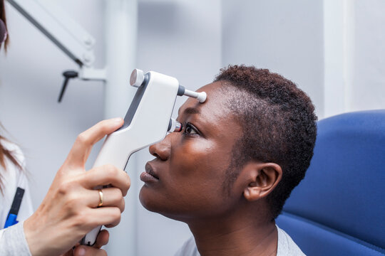 Black woman in optometry cabinet