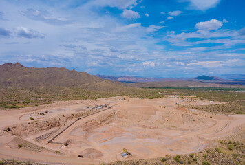 Arizona desert view as mining from above aerial view of excavator in open cast mine in heavy industry