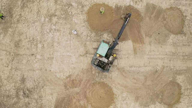 Malaysia, June 07, 2020 : Aerial view of backhoe is digging grove in the agricultural garden area to grow durian aerial. 4k footage