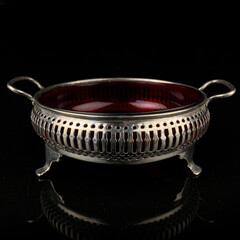 silver antique sugar bowl. metal retro sugar bowl on black background