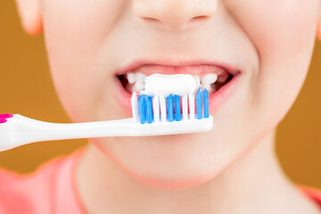 Health care, dental hygiene. Joyful child shows toothbrushes. Little boy cleaning teeth. Dental hygiene. Happy little kid brushing her teeth. Kid boy brushing teeth. Boy toothbrush white toothpaste