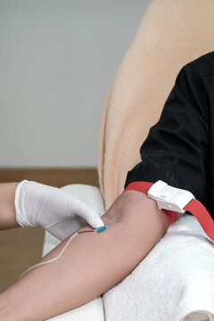 Nurse Or Lab Technician Drawing Blood Samples Using A Catheter And Tube Holder In The Hospital Clinic