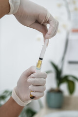 Close up of nurse or doctor extracting plasma from blood tube sample for PRP procedure - Platelet...