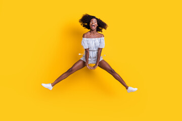 Fototapeta na wymiar Full length body size view of attractive cheerful crazy ecstatic fit girl jumping having fun good mood isolated over bright yellow color background