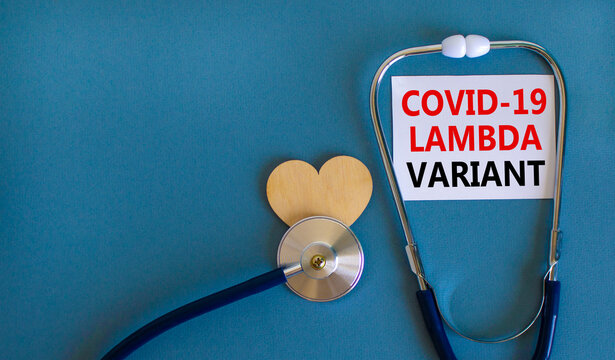 Covid-19 lambda variant strain symbol. White card, words Covid-19 lambda variant, stethoscope, blue background. Wood heart. Medical and covid-19 lambda variant strain concept, copy space.