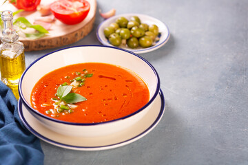 Plate of traditional spanish gazpacho in the background ingredients