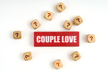 On the table are cubes with questions and a red plaque with the inscription - Couple Love
