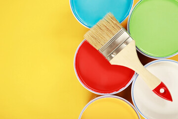 Paint brush and green, yellow, red, blue, white paint, interior wall paint with home renovation