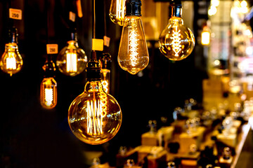 Soft focus of Light bulb night time in market shop with walking Street