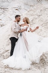 Beautiful wedding couple bride and groom at wedding day outdoors at ocean beach. Happy marriage couple o