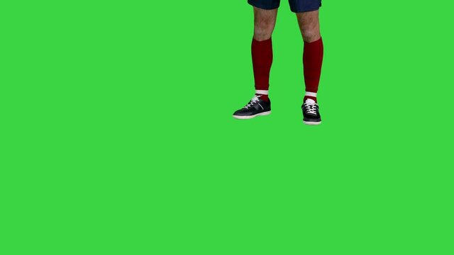 Football player giving a pass on a Green Screen, Chroma Key.
