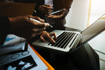 Business team brainstorming and discussing with financial data and report graph