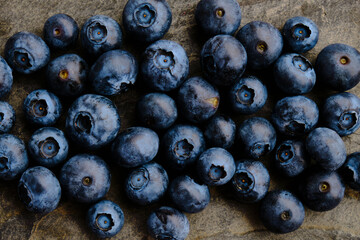 Closeup of delicious blueberries on grey slate background - Horizontal