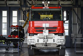 the fire truck is in the garage box of the fire station