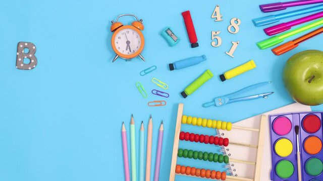 Back to school stationery and text appear on blue theme. Stop motion