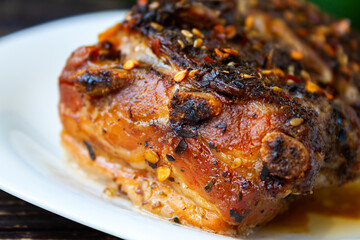 Spicy fried brisket with interlayers of pork lard baked with herbs, close-up selective focus